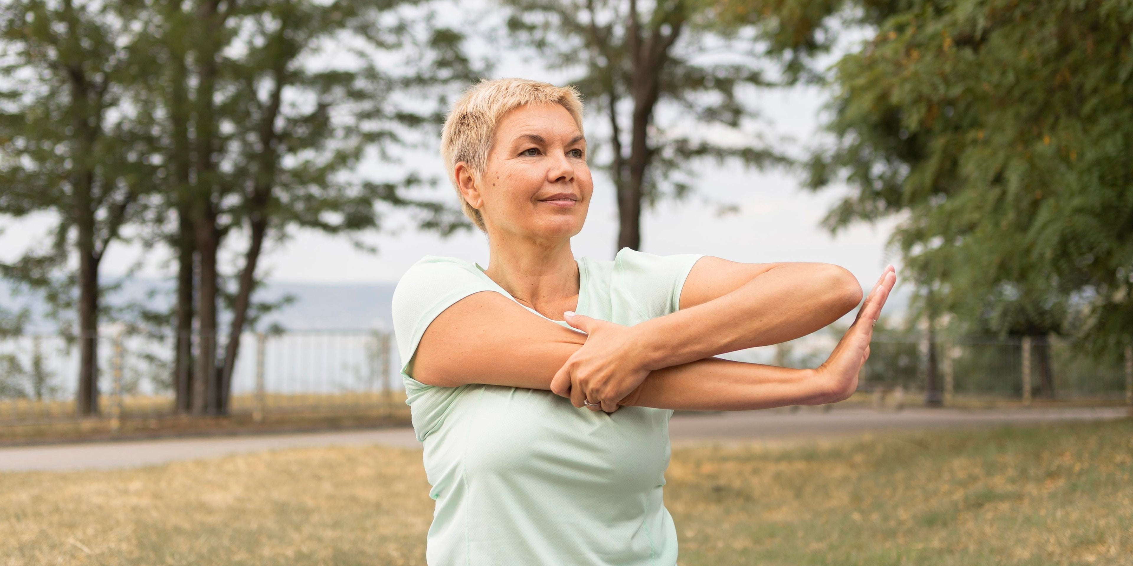Woman practising gentle movement outdoors - VitCornu mindful longevity